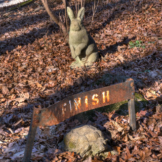 Stone tortoise winning a race against a stone hare